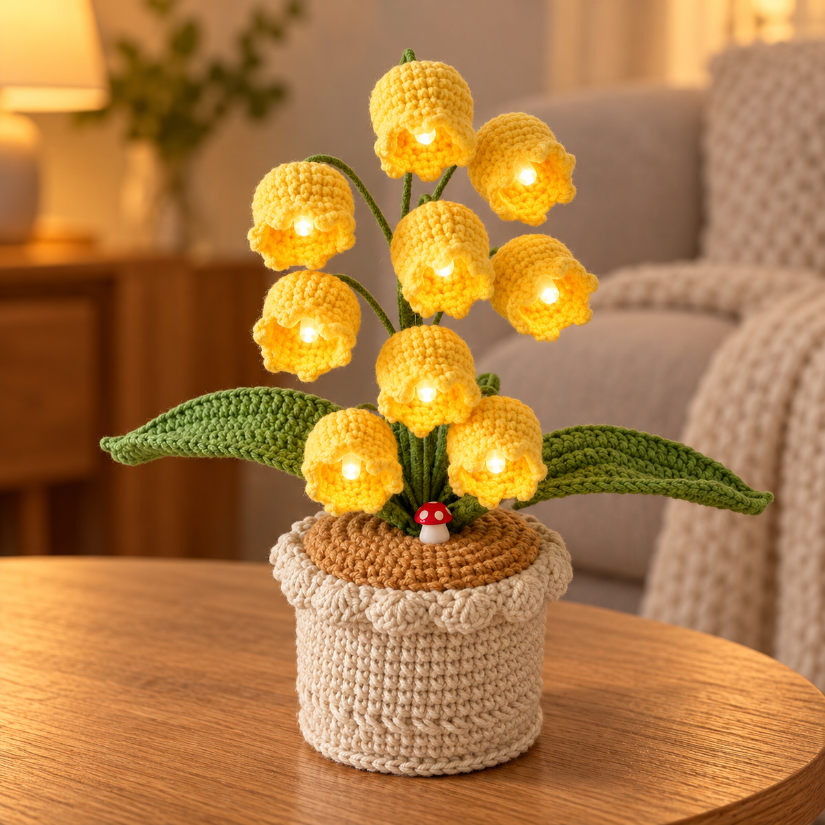 Buttercup lily of the valley crochet lamp with warm-white lights on an oak table