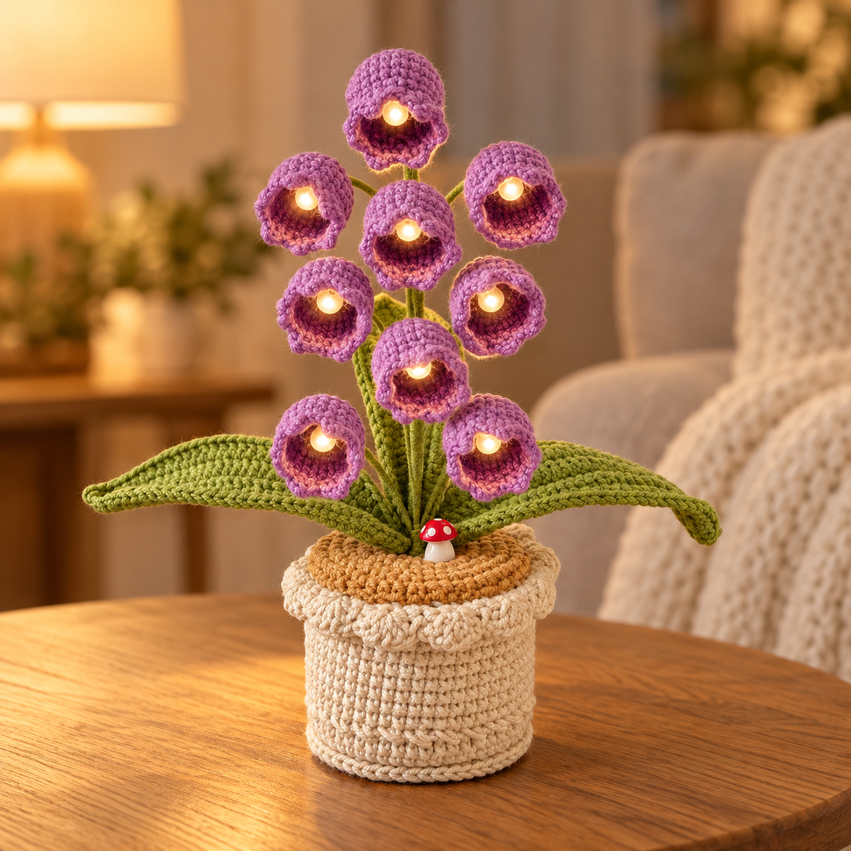 Lilac lily of the valley crochet lamp with warm-white lights on an oak table