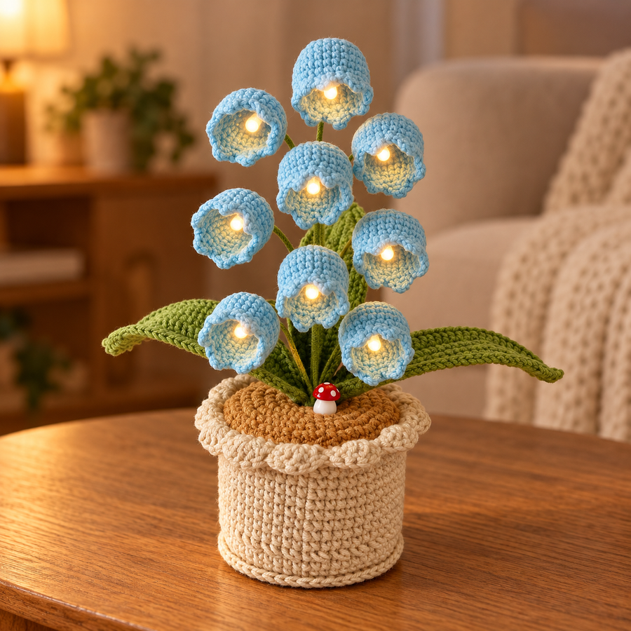 Sky Blue lily of the valley crochet lamp with warm-white lights on an oak table